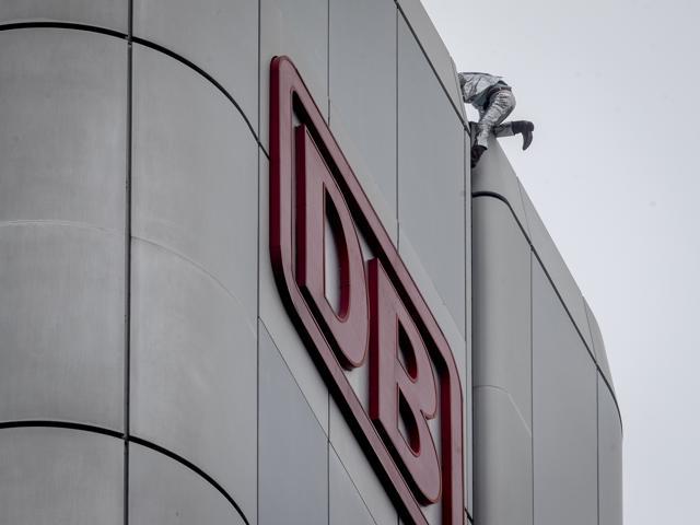 French urban climber Alain Robert reaches the top of the Deutsche Bahn high-rise. (AP)