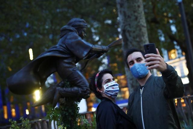 People take a selfie with a statue of Harry Potter, based on the JK Rowling novels, after it was unveiled at Leicester Square in London, Britain. (REUTERS)