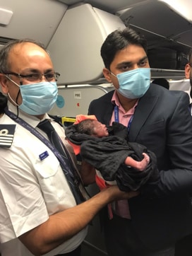 Two of the cabin crew members of the Indigo flight with the baby boy. (Sourced) Two of the cabin crew members of the Indigo flight with the baby boy. (Sourced)