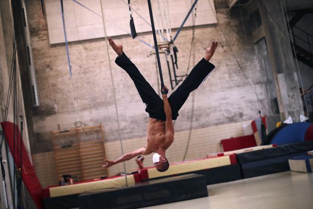 A student, wearing a face masks to fight against the spread of the coronavirus, works out his performance during a class at the Superior School of Circus (ESAC) in Brussels. (AP) A student, wearing a face masks to fight against the spread of the coronavirus, works out his performance during a class at the Superior School of Circus (ESAC) in Brussels. (AP)