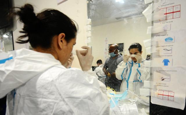 A young healthcare professional puts a tape over her nose to keep her face mask in place before she starts her shift. (Ravi Kumar) A young healthcare professional puts a tape over her nose to keep her face mask in place before she starts her shift. (Ravi Kumar)