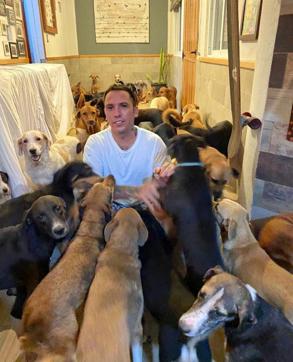 In this Oct. 7, 2020, photo provided by Daniela Rojas, Ricardo Pimentel plays with dogs that he sheltered at his home in Leona Vicario, Mexico, during Hurricane Delta. (AP) In this Oct. 7, 2020, photo provided by Daniela Rojas, Ricardo Pimentel plays with dogs that he sheltered at his home in Leona Vicario, Mexico, during Hurricane Delta. (AP)