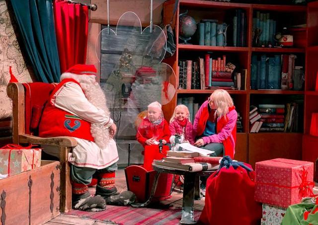 Santa Claus talks to Edvin, his sister Elsa and their mother Anu behind a plexiglas screen in his chamber at Santa Claus Village in the Arctic Circle near Rovaniemi, Finland. (REUTERS) Santa Claus talks to Edvin, his sister Elsa and their mother Anu behind a plexiglas screen in his chamber at Santa Claus Village in the Arctic Circle near Rovaniemi, Finland. (REUTERS)