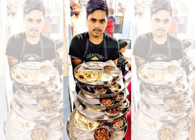 Tikku clicked a young waiter sporting his first moustache balancing five heavy plates at Kesar Da Dhaba Tikku clicked a young waiter sporting his first moustache balancing five heavy plates at Kesar Da Dhaba