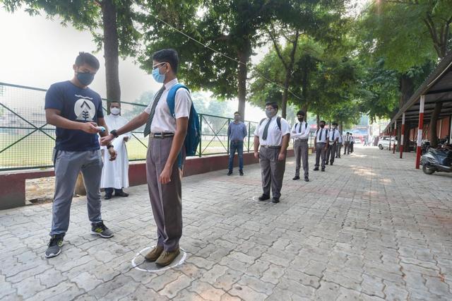 Lucknow: Students get their hands sanitised before entering their school (PTI) Lucknow: Students get their hands sanitised before entering their school (PTI)