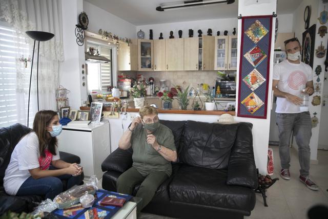 Itamar Glazer, right, Israeli volunteer Sharon Yaron, left, and 85-year-old Sara Weinsten. (AP) Itamar Glazer, right, Israeli volunteer Sharon Yaron, left, and 85-year-old Sara Weinsten. (AP)