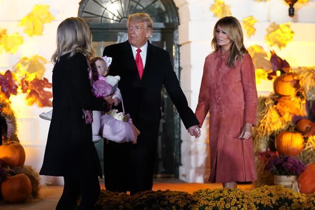 President Donald Trump and first lady Melania Trump greet trick-or-treaters on the South Lawn. (AP)
