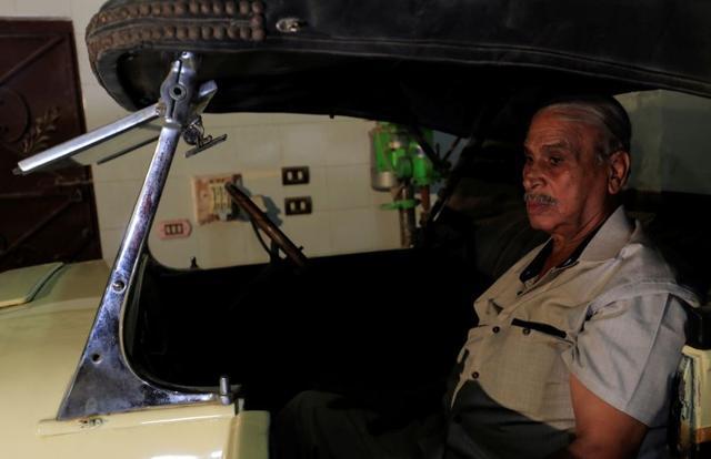 Sayed Sima, an Egyptian collector of vintage cars, sits in a 120-year-old American "1900 Auburn" . (REUTERS) Sayed Sima, an Egyptian collector of vintage cars, sits in a 120-year-old American "1900 Auburn" . (REUTERS)