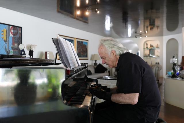 Brazilian conductor and pianist Joao Carlos Martins plays the piano with bionic gloves. (REUTERS) Brazilian conductor and pianist Joao Carlos Martins plays the piano with bionic gloves. (REUTERS)