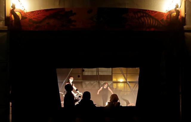 Spectators view a theatre performance by an artistic group Cirk La Putyka called "Culture take-away window", amid the coronavirus disease (COVID-19) outbreak, in Prague, Czech Republic. (REUTERS) Spectators view a theatre performance by an artistic group Cirk La Putyka called "Culture take-away window", amid the coronavirus disease (COVID-19) outbreak, in Prague, Czech Republic. (REUTERS)