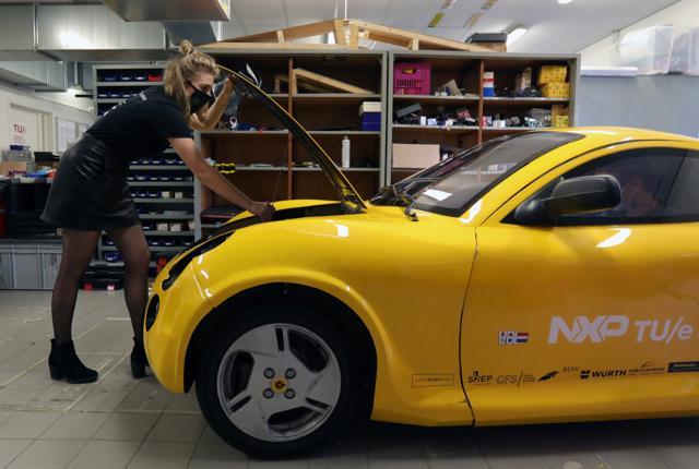 Student Lisa van Etten, project manager TU/ecomotive takes out the battery from a car made from recycled waste in Eindhoven, Netherlands. (REUTERS)