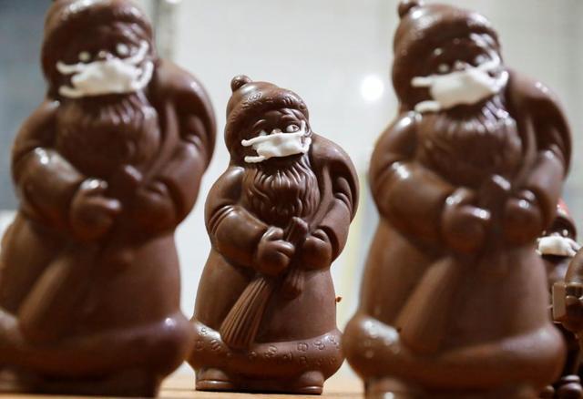 Chocolate Santas wearing protective face masks are seen in the workshop of the Hungarian confectioner Laszlo Rimoczi, during the coronavirus disease (COVID-19) outbreak in Lajosmizse, Hungary. (REUTERS)
