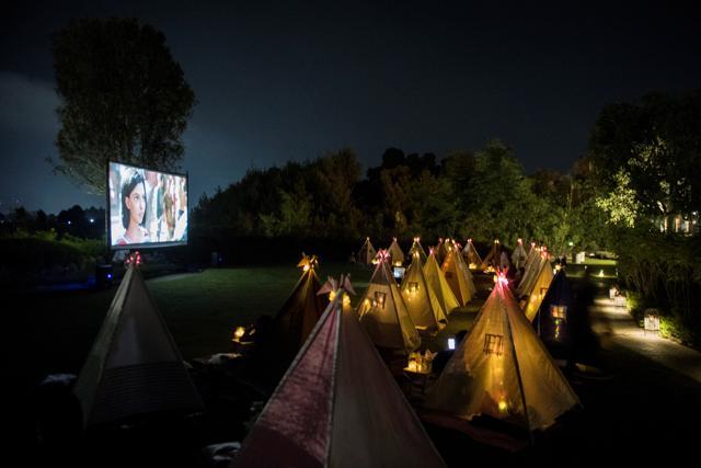 People watch movies from tents placed for social distancing at the campsites in Bandung, West Java Province, Indonesia. (Via REUTERS) People watch movies from tents placed for social distancing at the campsites in Bandung, West Java Province, Indonesia. (Via REUTERS)