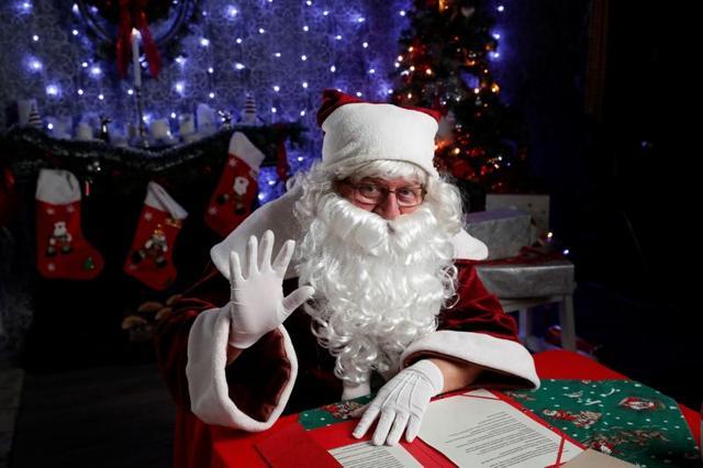 Janos Nemes, dressed as Santa Claus, waves as he interacts with children by video. (REUTERS) Janos Nemes, dressed as Santa Claus, waves as he interacts with children by video. (REUTERS)