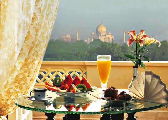 At The Oberoi Amarvilas, breakfast is served overlooking a garden, beyond which the Taj Mahal looms in all its majesty and beauty At The Oberoi Amarvilas, breakfast is served overlooking a garden, beyond which the Taj Mahal looms in all its majesty and beauty