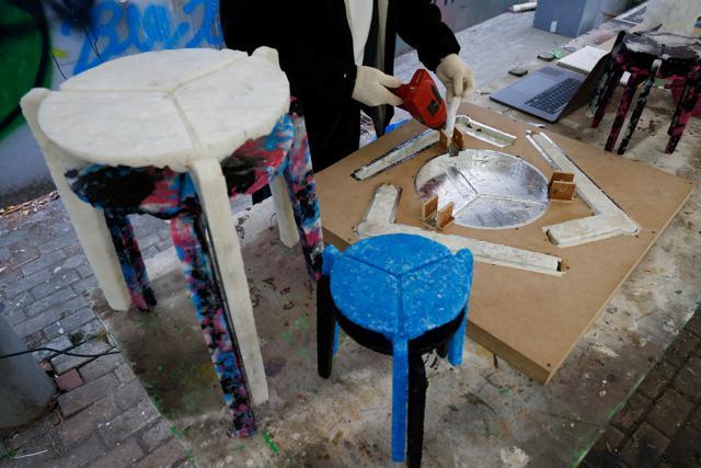 Kim Ha-neul, who is majoring in furniture design, melts discarded masks to make part of a stool in Uiwang, South Korea. (REUTERS) Kim Ha-neul, who is majoring in furniture design, melts discarded masks to make part of a stool in Uiwang, South Korea. (REUTERS)