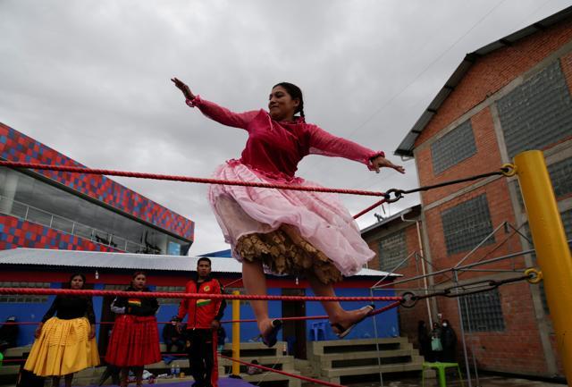 Gloria, a cholita wrestler, fights during their return to the ring after the coronavirus disease (COVID-19) restrictions, in El Alto outskirts of La Paz. (REUTERS)