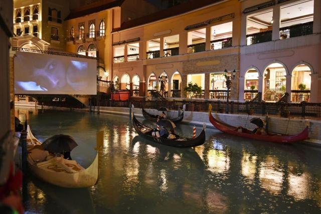 People on gondolas watch a movie while observing social distancing. (REUTERS) People on gondolas watch a movie while observing social distancing. (REUTERS)