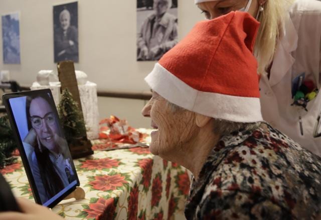 Caterina Bertocchi, 91, talks via video call with Irene Schiavone, a donor unrelated to her, who bought and sent her a Christmas present through an organization dubbed "Santa's Grandchildren", at the Martino Zanchi nursing home in Alzano Lombardo, one of the area that most suffered the first wave of COVID-19, in northern Italy. (AP) Caterina Bertocchi, 91, talks via video call with Irene Schiavone, a donor unrelated to her, who bought and sent her a Christmas present through an organization dubbed "Santa's Grandchildren", at the Martino Zanchi nursing home in Alzano Lombardo, one of the area that most suffered the first wave of COVID-19, in northern Italy. (AP)