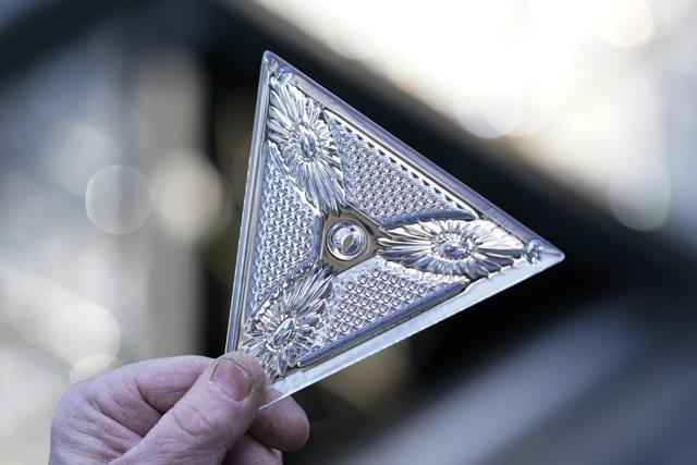 A worker holds one of the 192 Waterford crystal triangles that will be placed on the Times Square New Year's Eve ball, Sunday, Dec. 27, 2020, in New York. (AP)