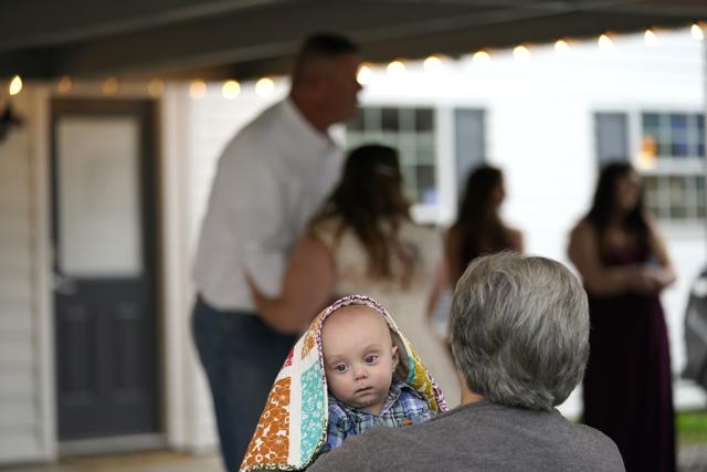 Theresa Kitfield holds her great grandson Beau Kitifield as her granddaughter Emily Pascale dances with her father, Eric Kitfield, after her wedding to Taylor Pascale outside the home of Taylor's parents, which was heavily damaged from Hurricanes Laura and Delta. (AP) Theresa Kitfield holds her great grandson Beau Kitifield as her granddaughter Emily Pascale dances with her father, Eric Kitfield, after her wedding to Taylor Pascale outside the home of Taylor's parents, which was heavily damaged from Hurricanes Laura and Delta. (AP)
