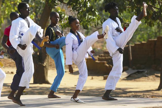 Natsiraishe Maritsa, second right, goes through taekwondo kicking drills during a practice session in the Epworth settlement about 15 km southeast of the capital Harare. In Zimbabwe, where girls as young as 10 are forced to marry due to poverty or traditional and religious practices, a teenage martial arts fan 17-year old Natsiraishe Maritsa is using the sport to give girls in an impoverished community a fighting chance at life. (AP) Natsiraishe Maritsa, second right, goes through taekwondo kicking drills during a practice session in the Epworth settlement about 15 km southeast of the capital Harare. In Zimbabwe, where girls as young as 10 are forced to marry due to poverty or traditional and religious practices, a teenage martial arts fan 17-year old Natsiraishe Maritsa is using the sport to give girls in an impoverished community a fighting chance at life. (AP)