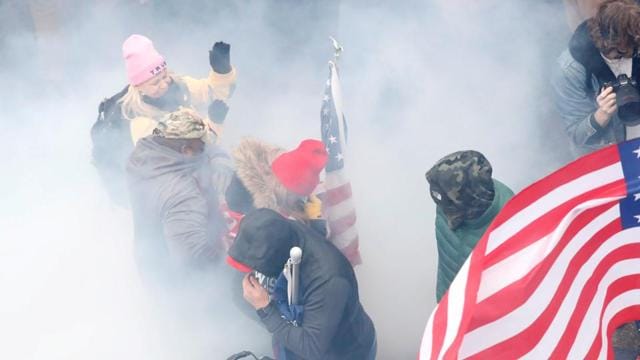 Pro-Trump protesters react amidst a cloud of tear gas during clashes with Capitol police (REUTERS) Pro-Trump protesters react amidst a cloud of tear gas during clashes with Capitol police (REUTERS)