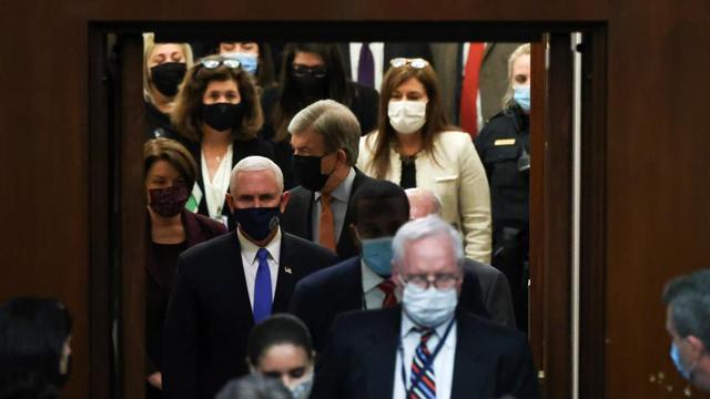 US Vice President Mike Pence enters the House chamber, after the Congress reconvened to certify the Electoral College votes of the 2020 presidential election, in Washington, US. (REUTERS) US Vice President Mike Pence enters the House chamber, after the Congress reconvened to certify the Electoral College votes of the 2020 presidential election, in Washington, US. (REUTERS)