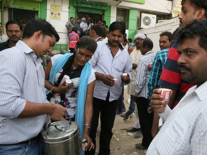 At queues outside Delhi banks people share, collaborate, socialise ...