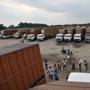 Trailer truck drivers wait their turn at a parking yard where they bid time after a slowdown in the auto sector.