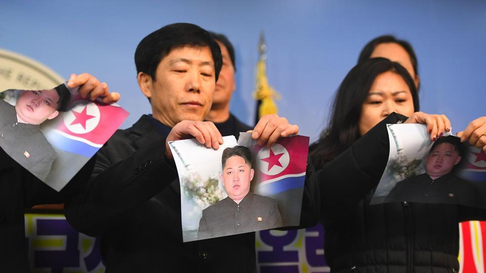 Activists Rip Kim Jong Uns Photo To Protest North Koreas