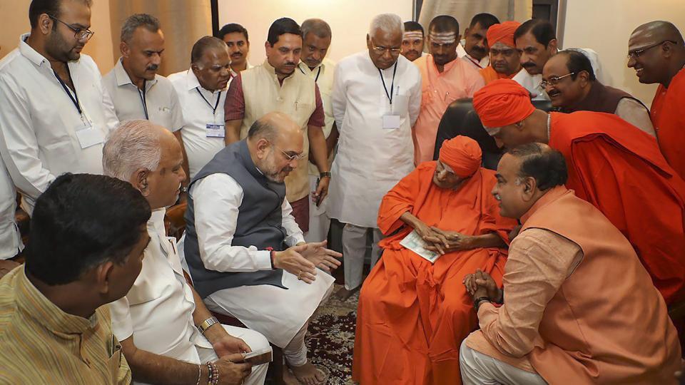 BJP president Amit Shah meeting the then chief pontiff of Siddaganga Mutt Shivakumara Swamiji, in Tumakuru. (PTI Photo) BJP president Amit Shah meeting the then chief pontiff of Siddaganga Mutt Shivakumara Swamiji, in Tumakuru. (PTI Photo)