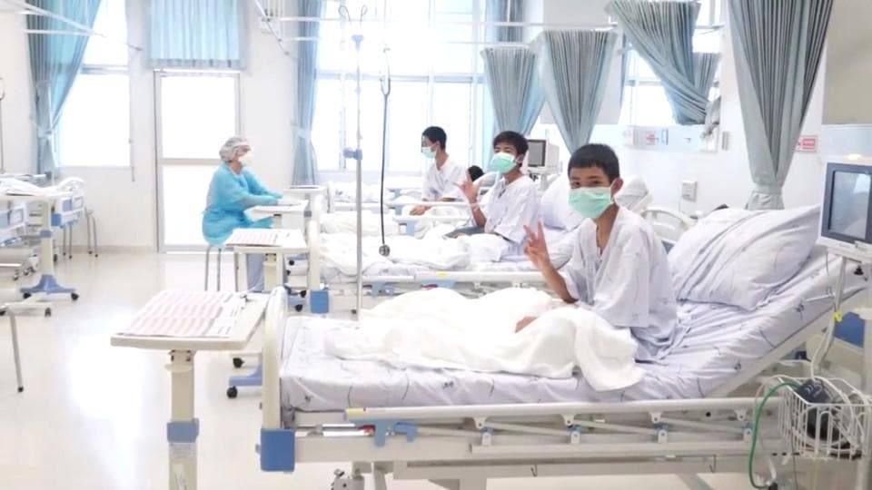 Thai boys wave, make peace sign in first photo since their rescue