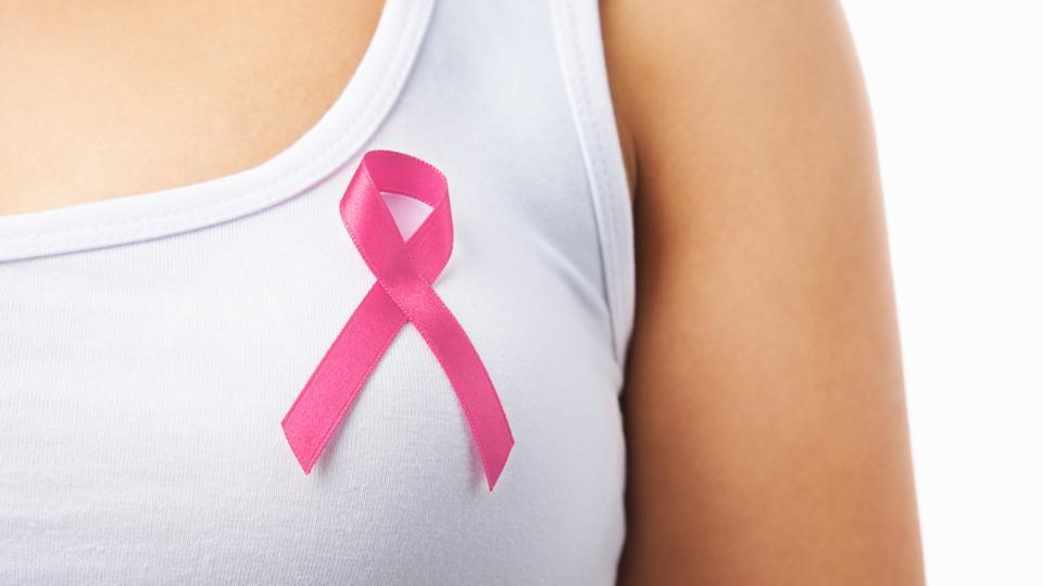 Field hockey players pause to 'support breast cancer awareness' at a recent  game 