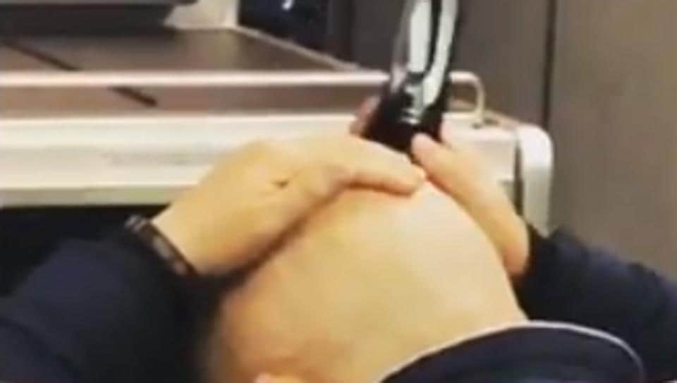 Man shaves his head mid-flight in bizarre video. Internet is repulsed