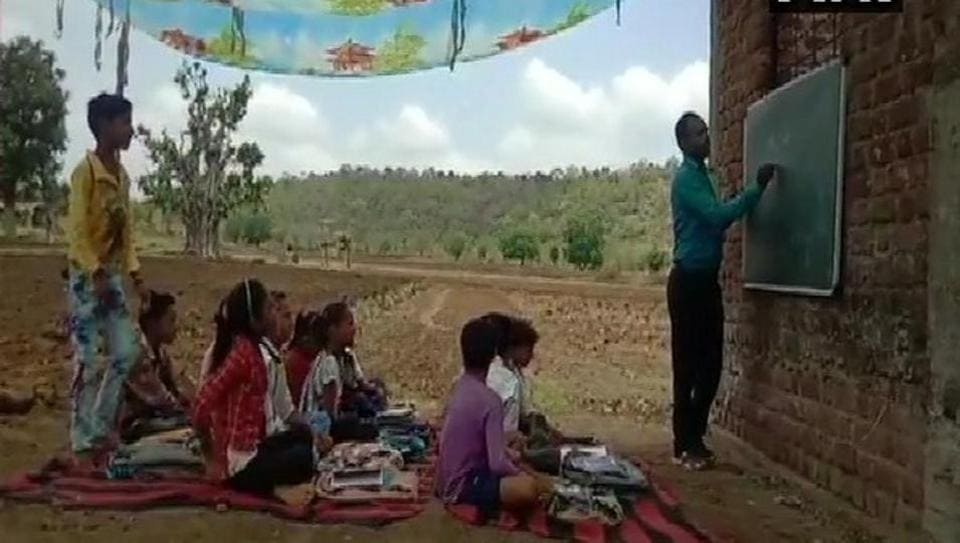 In scorching heat, students in this MP school study under makeshift tent