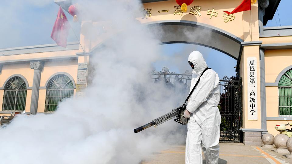 Volunteer disinfectant sprayers help Wuhan prepare for a return to work ...