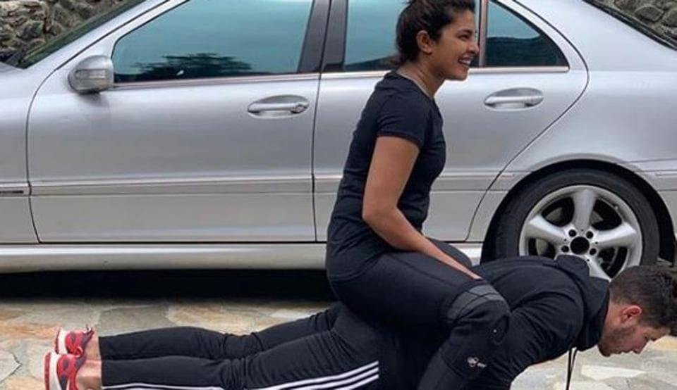 Priyanka Chopra hitches a ride on Nick Jonas’ back while he does push-ups. See pic here