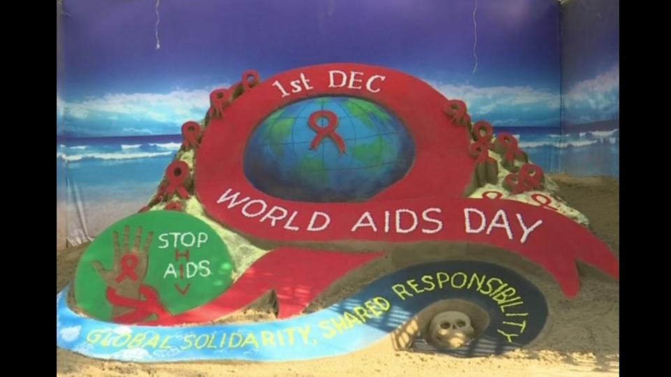 Sand artist creates sculpture to spread awareness on World AIDS Day in ...