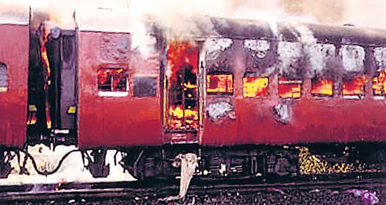◼ A coach of a train, carrying Hindu pilgrims, burns in Gujarat’s Godhra. (REUTERS FILE) ◼ A coach of a train, carrying Hindu pilgrims, burns in Gujarat’s Godhra. (REUTERS FILE)