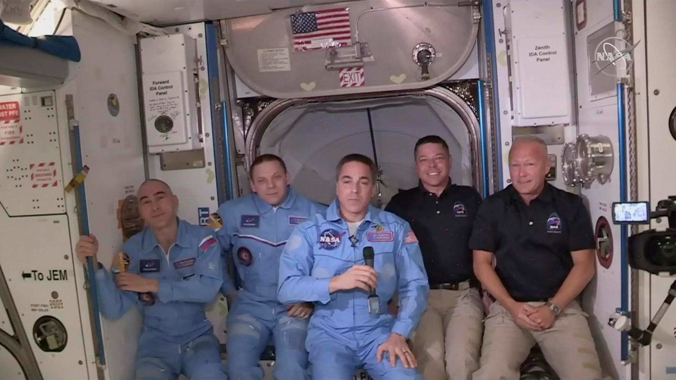 This photo provided by NASA shows Bob Behnken and Doug Hurley, far right, joining the the crew at the International Space Station, after the SpaceX Dragon capsule pulled up to the station and docked Sunday, May 31, 2020.
