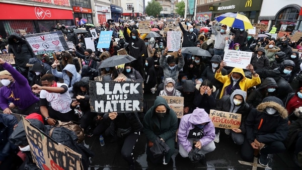 Demonstrators wearing protective face masks and face coverings hold placards during a Black Lives Matter protest in Leicester, following the death of George Floyd who died in police custody in Minneapolis, Leicester, Britain, June 6, 2020.