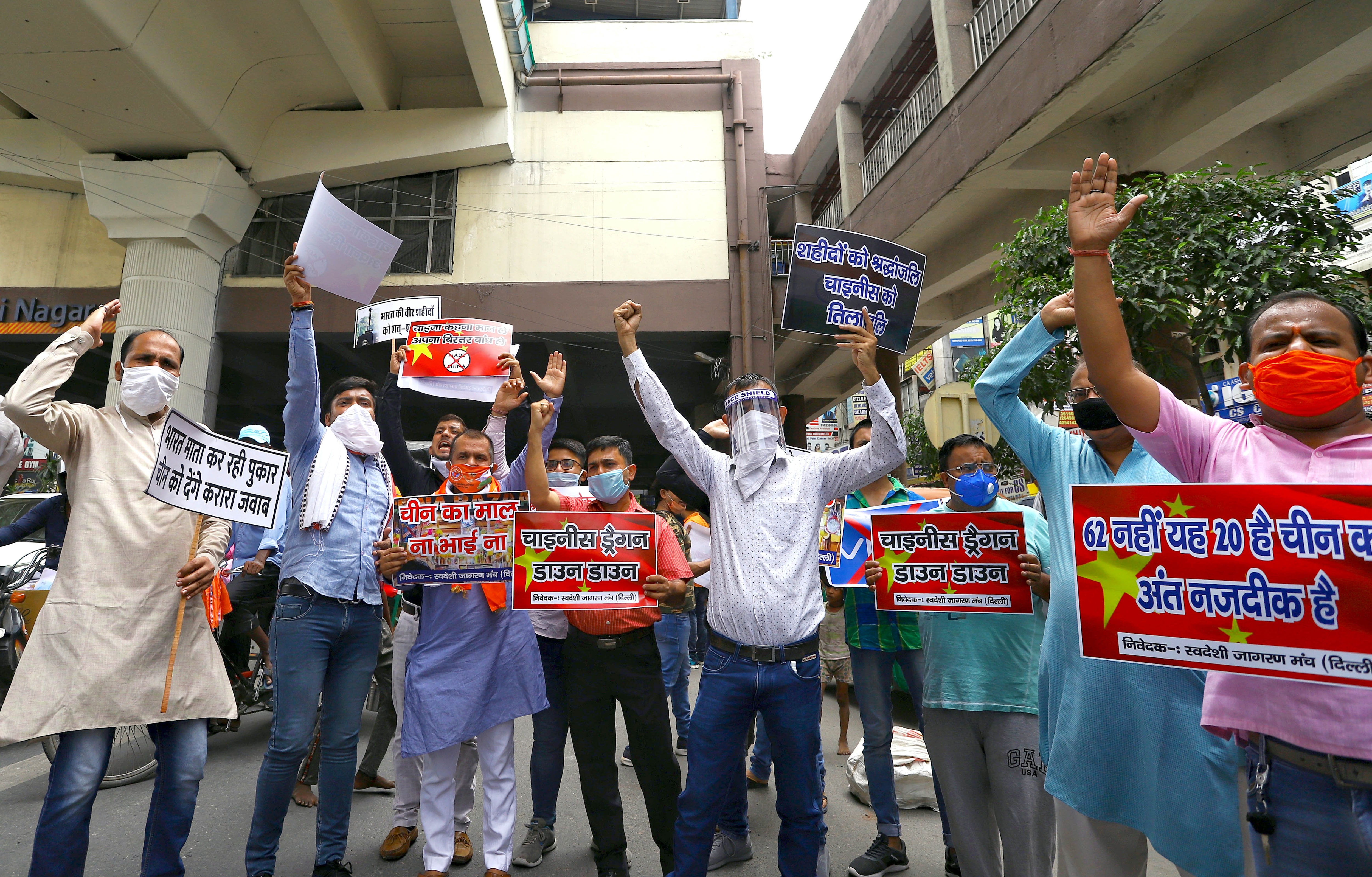Swadeshi Jagran Manch workers hold a placard and shout slogans as they protest against Chinese goods and against the killing of Indian soldiers during India China clash, at Laxmi Nagar in New Delhi on Saturday. Swadeshi Jagran Manch workers hold a placard and shout slogans as they protest against Chinese goods and against the killing of Indian soldiers during India China clash, at Laxmi Nagar in New Delhi on Saturday.
