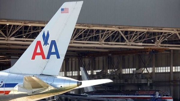An American Airlines airliner sits near a hanger at Dallas/Fort Worth International Airport, Texas. 