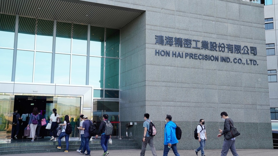 People enter the Hon Hai Precision Industry Co. headquarters ahead of the company's annual general meeting in New Taipei City, Taiwan, on Tuesday, June 23, 2020. Hon Hai, the main assembler of Apple's iPhone, is planning to make fresh investment in India 