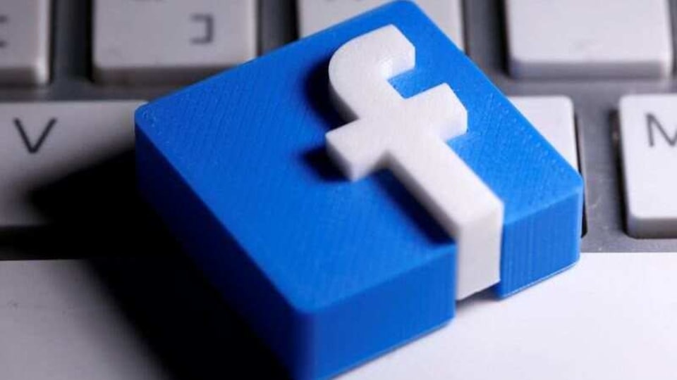 A 3D-printed Facebook logo is seen placed on a keyboard in this illustration taken March 25, 2020. 