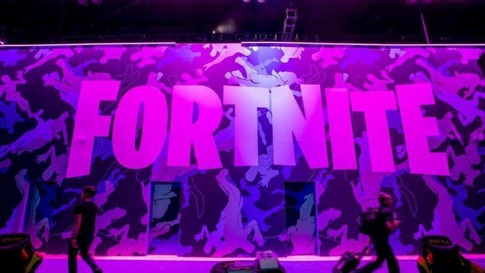 Attendees walk past signage for Epic Games Inc. Fortnite video game during the E3 Electronic Entertainment Expo in Los Angeles, California, U.S., on Wednesday, June 12, 2019.