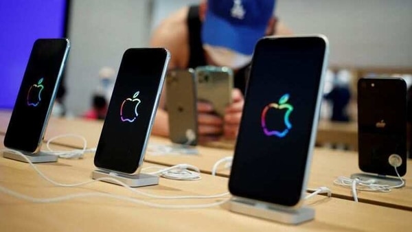 A man takes pictures of iPhones in the new Apple flagship store on its opening day following an outbreak of the coronavirus disease (COVID-19) in Sanlitun in Beijing, China, July 17, 2020. REUTERS/Thomas Peter/Files