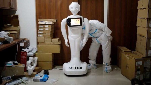 A medical worker puts robot named 'Mitra' , which is used by the patients suffering from the coronavirus disease (Covid-19) to communicate with their relatives, on charge at the Yatharth Super Speciality Hospital in Noida