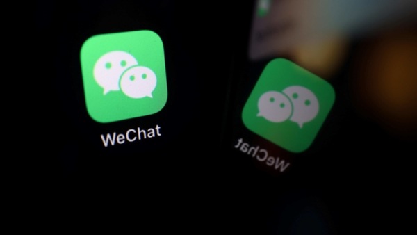 The sign of the WeChat app is seen reflected on a mobile phone in this illustration picture taken September 19, 2020. REUTERS/Florence Lo/Illustration